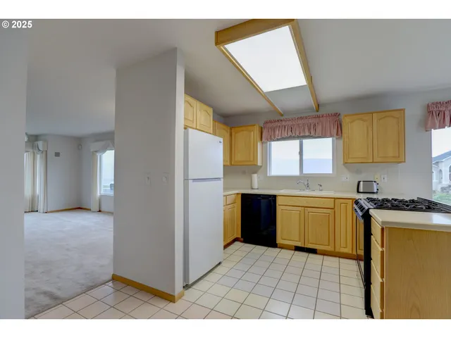 a kitchen with a refrigerator and a stove