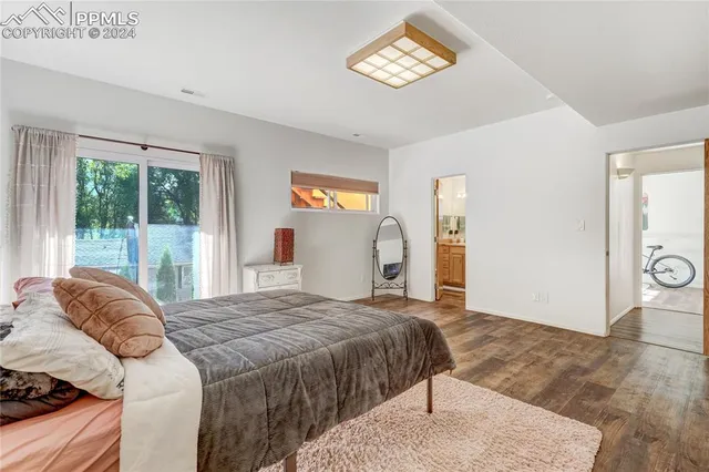 a bathroom with a granite countertop sink a mirror and a shower