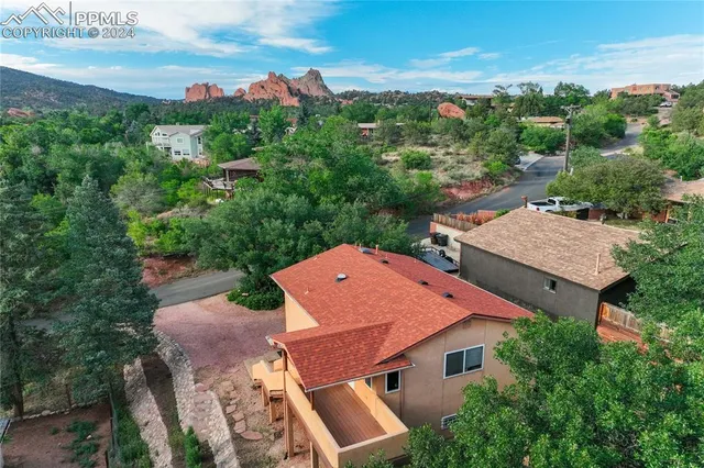 an aerial view of residential houses with outdoor space and ocean view