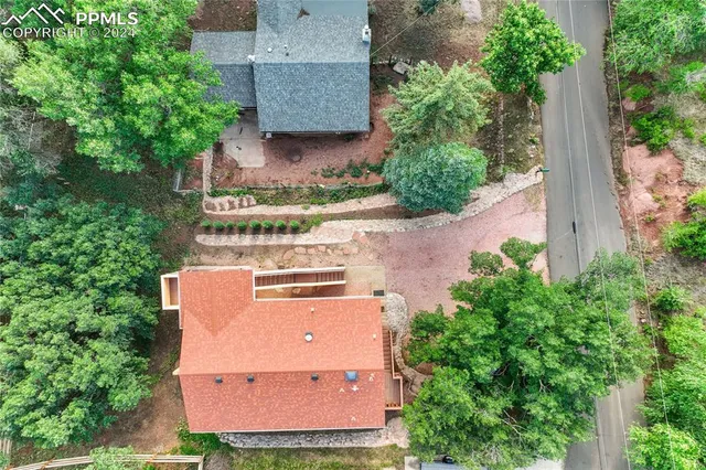 a living room with furniture a flat screen tv and a table
