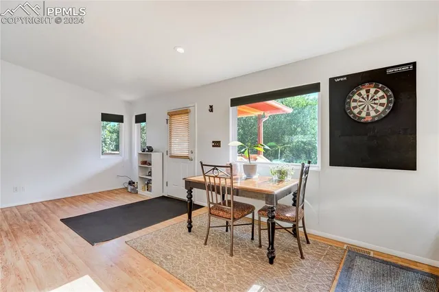 a view of a dining room with furniture window and wooden floor