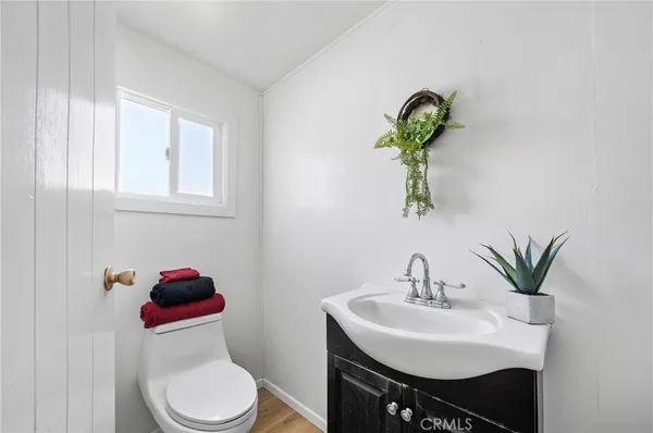 a bathroom with a sink toilet and a mirror