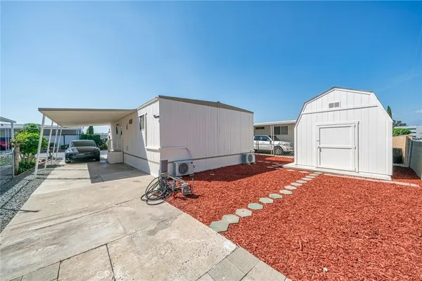 a view of a house with backyard porch and sitting area