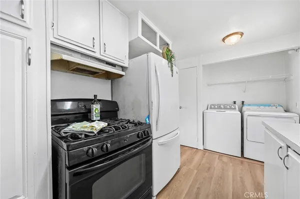 a kitchen with cabinets and steel appliances
