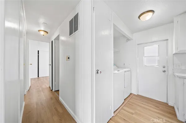 a view of hallway with wooden floor