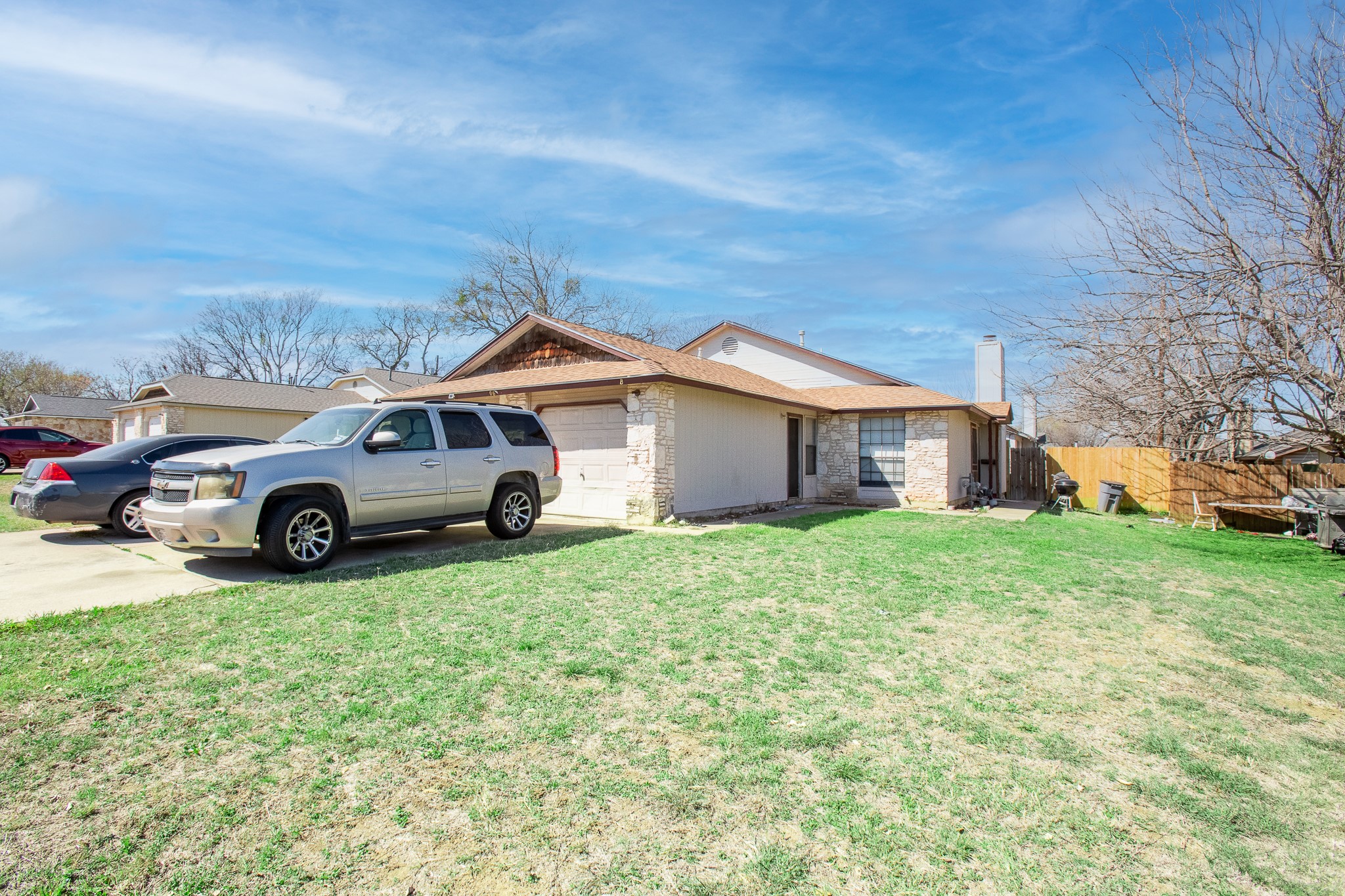 606 Misty Morning Way, Unit A AND B Round Rock, TX 78664 - Photo 4 of 22 View of home's exterior featuring an attached garage, concrete driveway, and a chimney