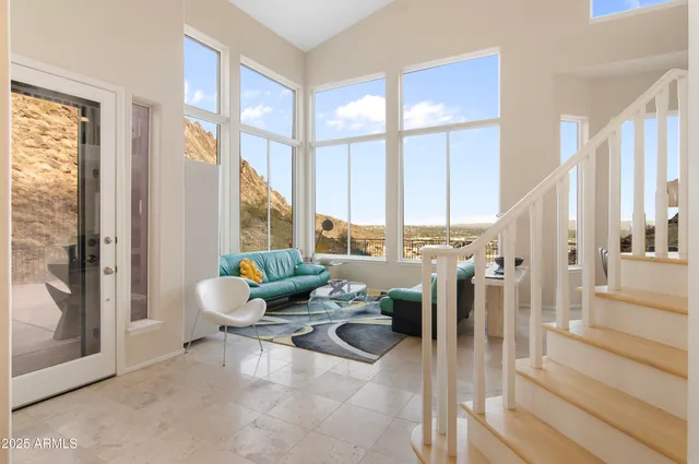 a living room with furniture and large windows