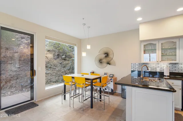a dining room with furniture and wooden floor