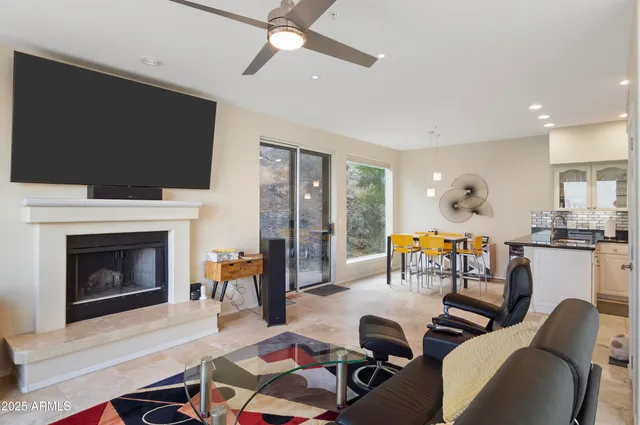 a living room with furniture a flat screen tv and a fireplace