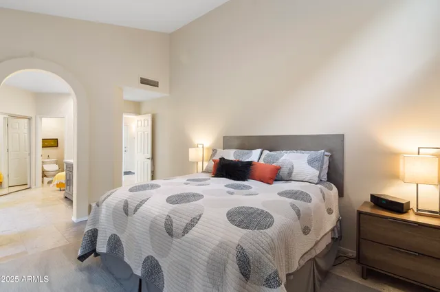 a bedroom with a bed and a lamp