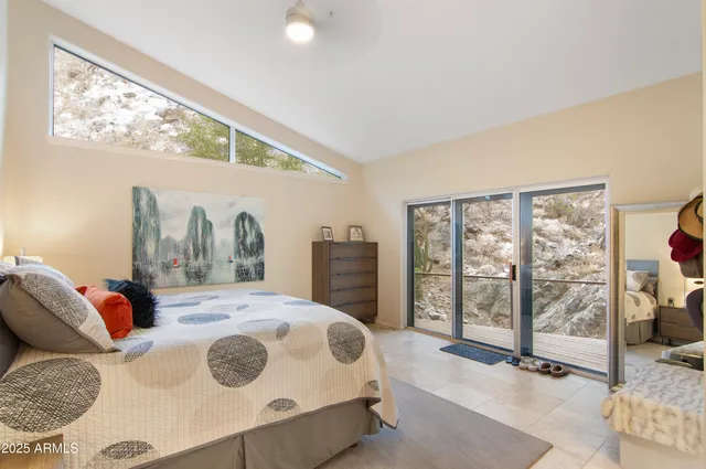 a bedroom with a large bed and a large window