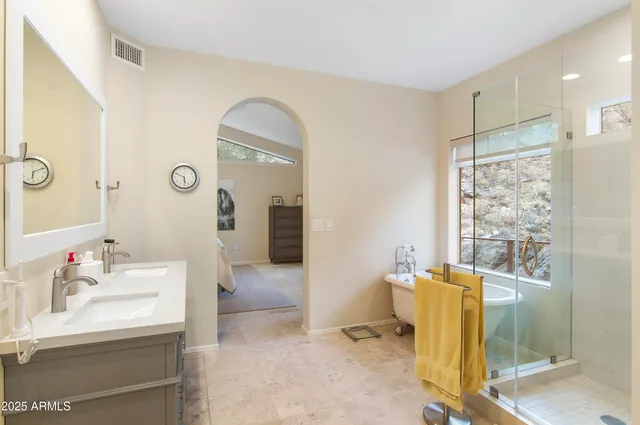 a spacious bathroom with a double vanity sink and a mirror