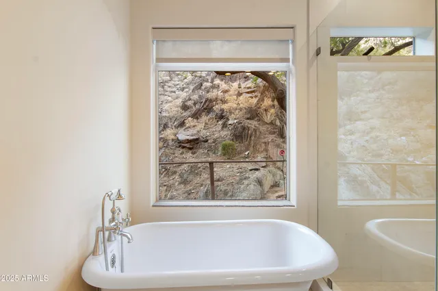 a white bath tub sitting next to a window
