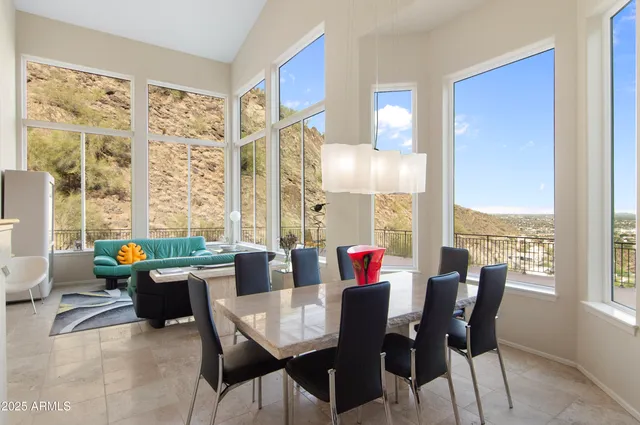 a dining room with furniture a chandelier and wooden floor