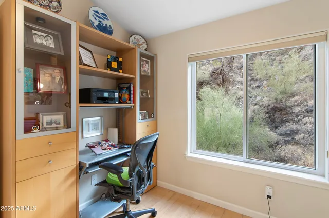 a view of workspace with wooden floor and a window