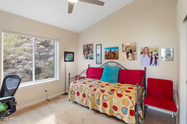 a bedroom with a bed and a couch next to a window