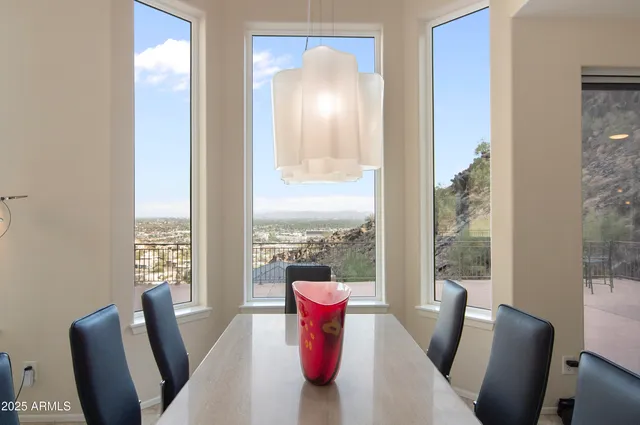 a view of a dining room with furniture a livingroom and windows