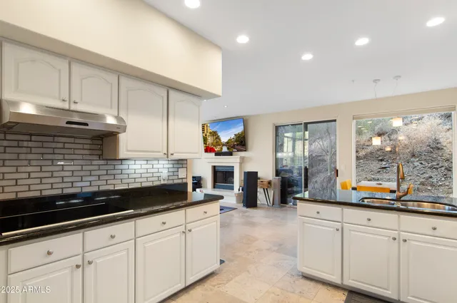 a kitchen with stainless steel appliances kitchen island granite countertop a sink and cabinets