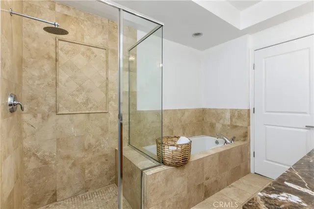 a bathroom with a granite countertop shower and a sink