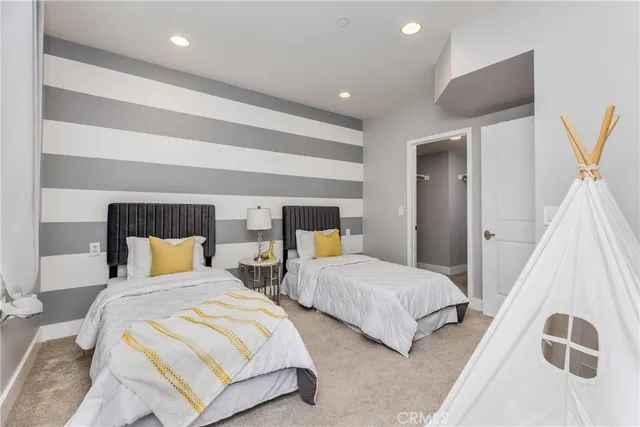 a bedroom with two beds and painted walls