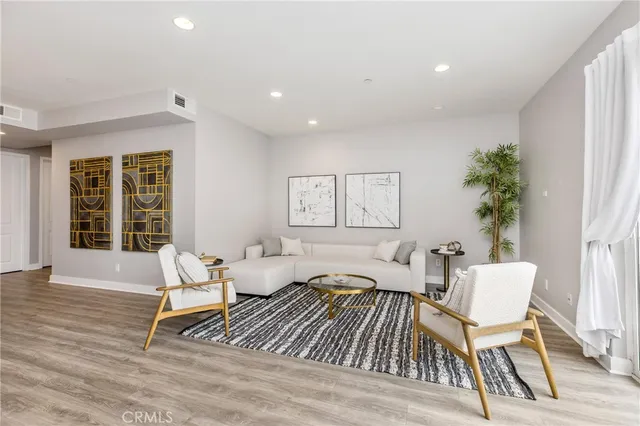 a living room with furniture and a potted plant