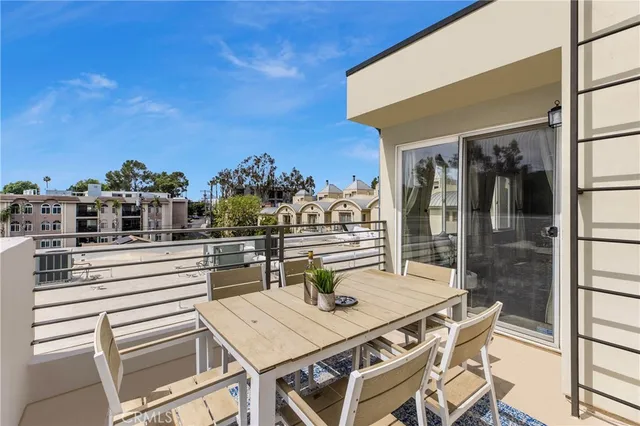 a view of a patio with table and chairs