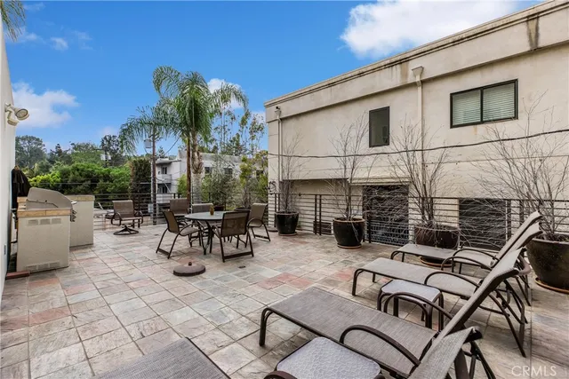a view of a patio with couches and potted plants