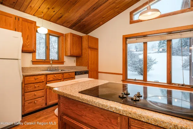 a kitchen with sink a window and cabinets