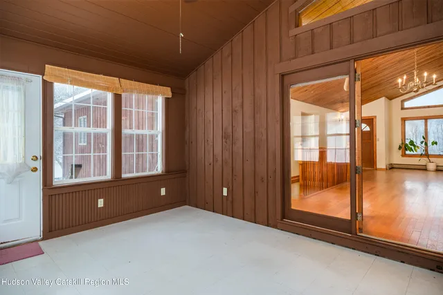 a view of an empty room with glass door and balcony