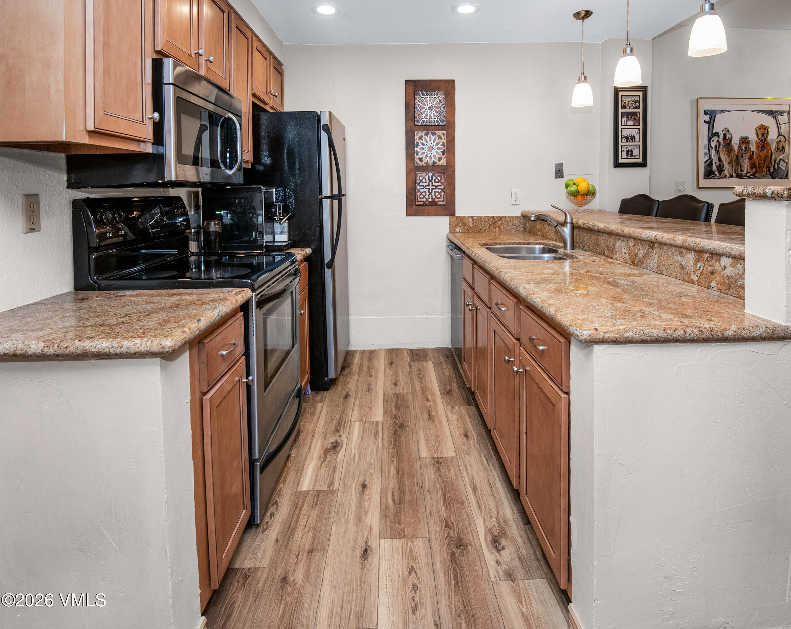 1650 Fall Ridge Road, Unit 202 Vail, CO 81657 - Photo 3 of 32 a kitchen with stainless steel appliances granite countertop a sink stove and refrigerator