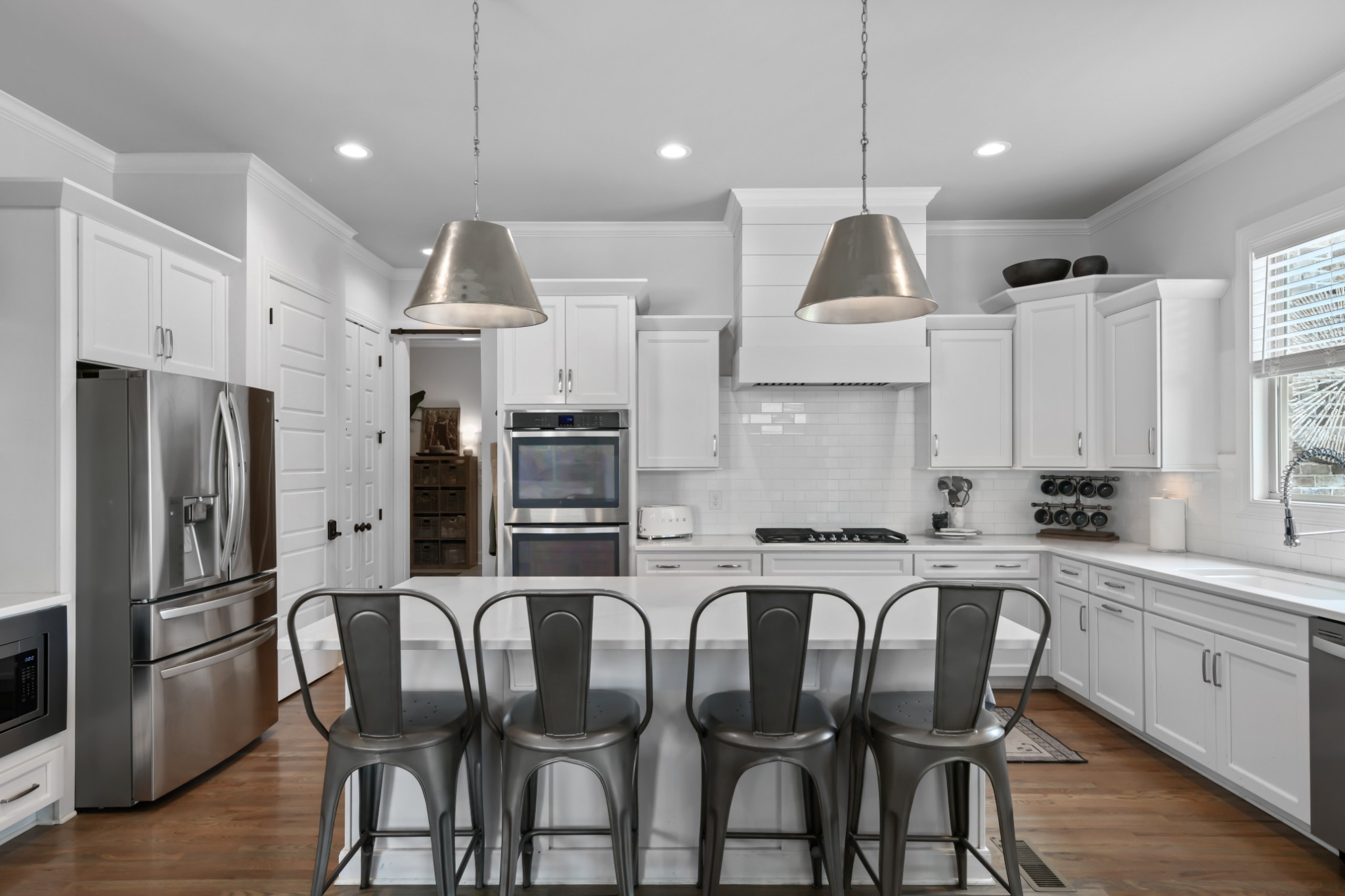 3577 Creamery Brg Road Thompson's Station, TN 37179 - Photo 6 of 42 a kitchen with stainless steel appliances granite countertop a dining table chairs refrigerator and microwave