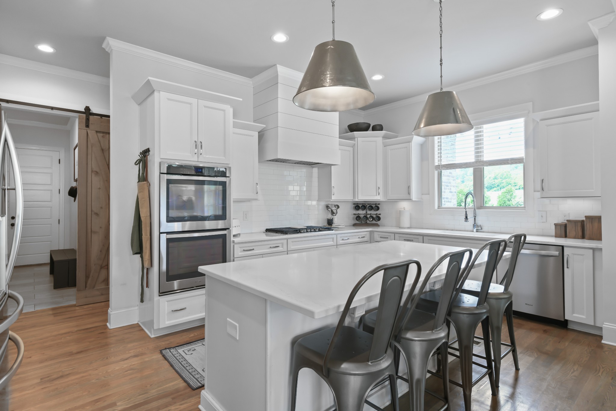 3577 Creamery Brg Road Thompson's Station, TN 37179 - Photo 7 of 42 a kitchen with stainless steel appliances a dining table chairs stove refrigerator and cabinets