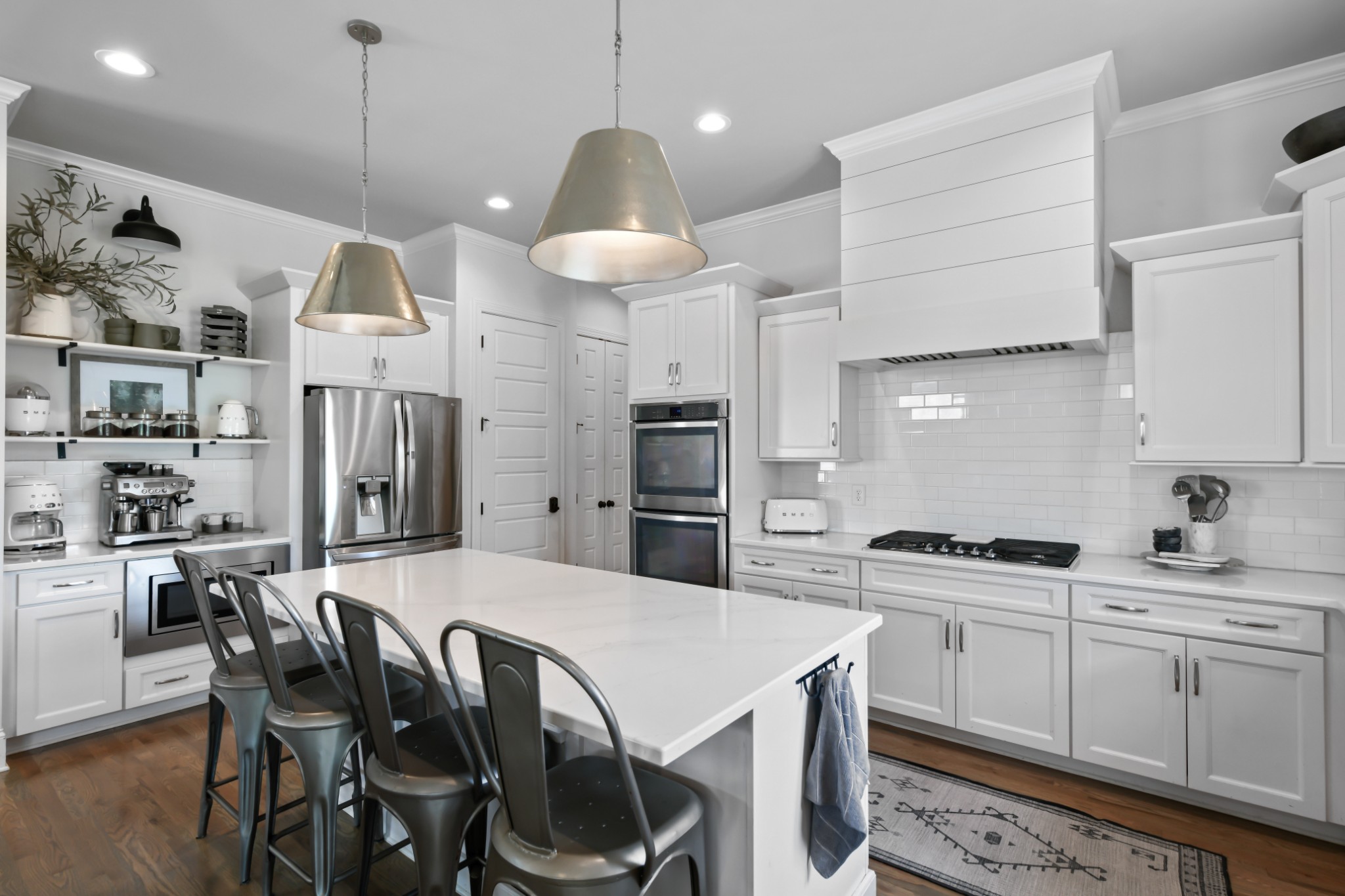 3577 Creamery Brg Road Thompson's Station, TN 37179 - Photo 8 of 42 a kitchen with stainless steel appliances kitchen island granite countertop a sink a stove a refrigerator and island with wooden floor
