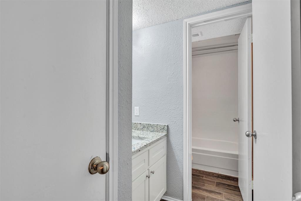 11311 Audelia Road, Unit 221 Dallas, TX 75243 - Photo 10 of 22 a bathroom with a granite countertop mirror and a sink