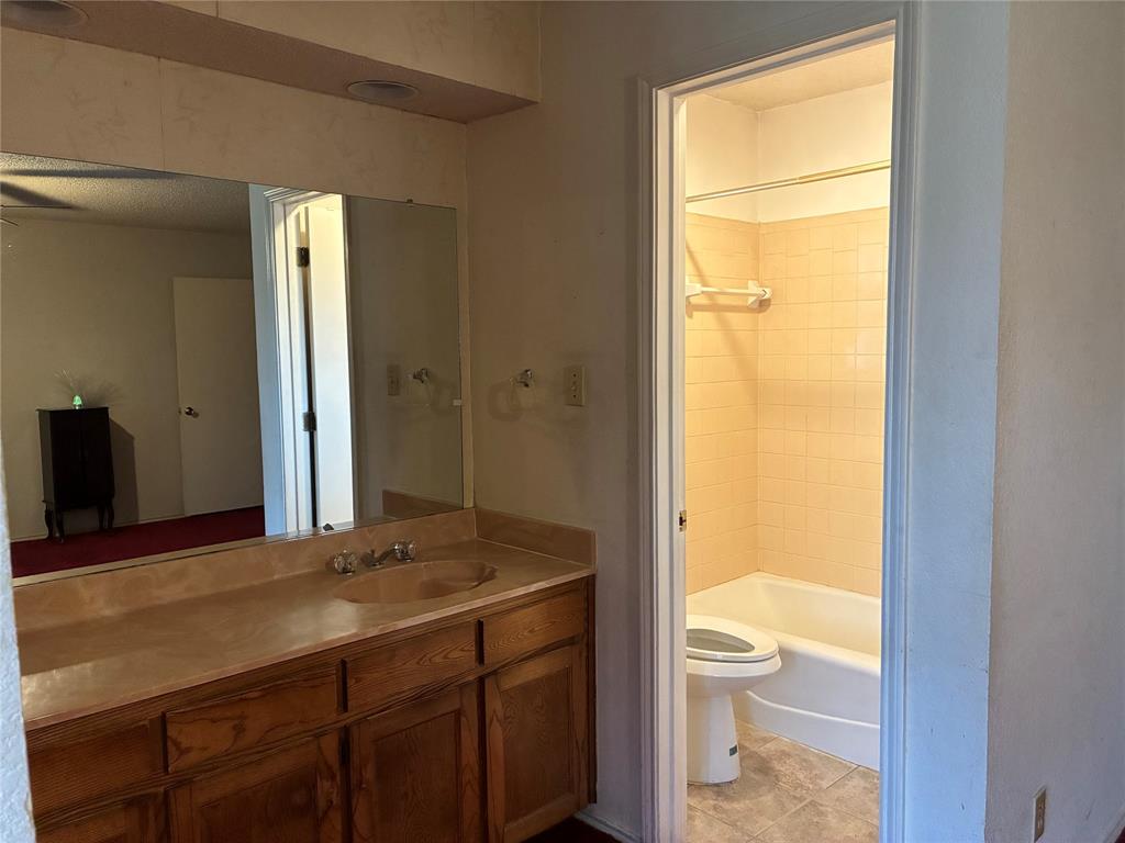 8430 Retta Mansfield Road Mansfield, TX 76063 - Photo 14 of 17 a bathroom with a granite countertop sink toilet and shower