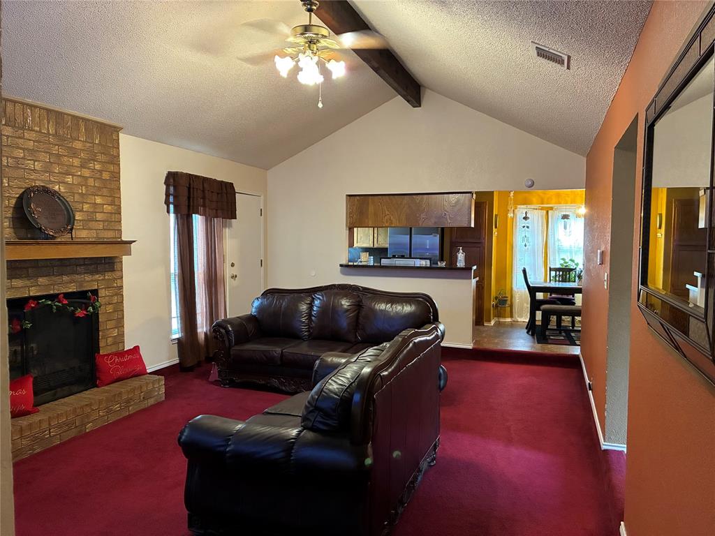8430 Retta Mansfield Road Mansfield, TX 76063 - Photo 8 of 17 a living room with furniture and a fireplace