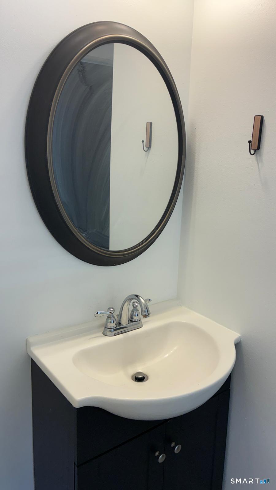 715 Frenchtown Road, Unit 4 Bridgeport, CT 06606 - Photo 5 of 6 a bathroom with a sink and a mirror