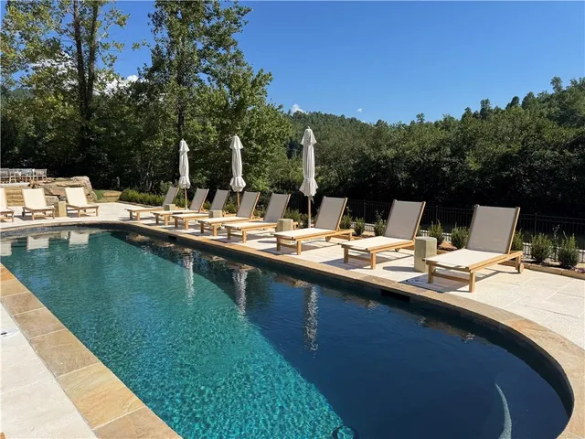 a view of swimming pool with outdoor seating