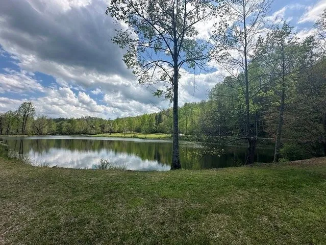 a small white house with a lake view