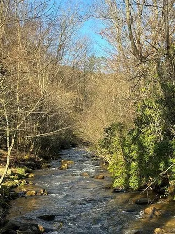 a backyard of a house with a yard and outdoor seating