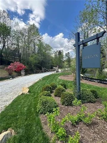a backyard of a house with lots of green space and fountain