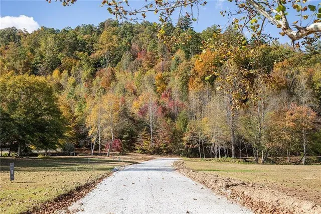 a view of a house with a yard and sitting area