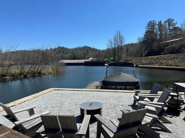 a view of a house with a yard and a fountain