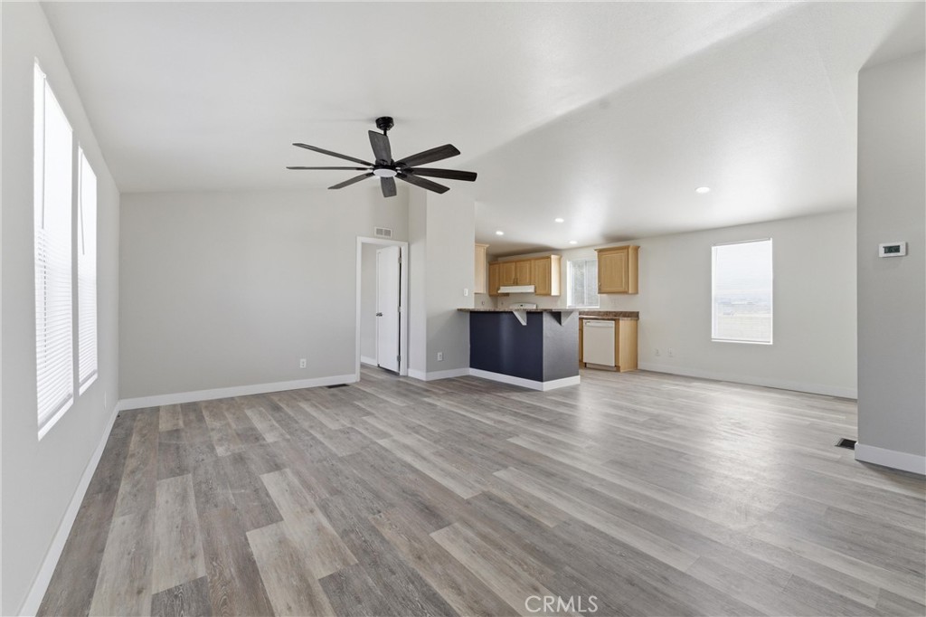 20843 Waalew Road, Unit C125 Apple Valley, CA 92307 - Photo 6 of 38 wooden floor in an empty room with a window