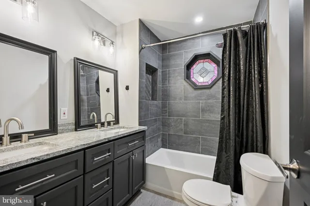 a bathroom with a sink a toilet and a bathtub