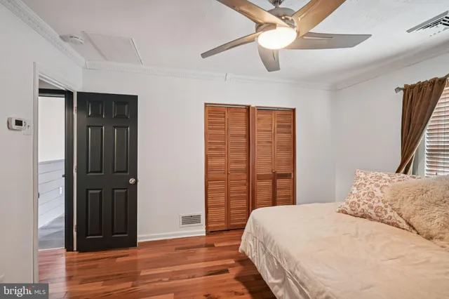 a bedroom with a bed closet and a window