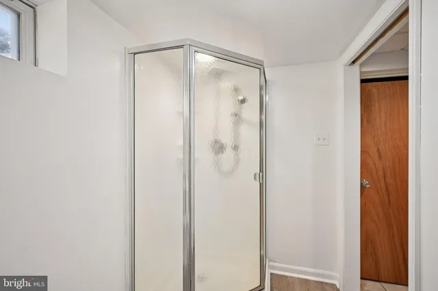 a bathroom with a glass shower door