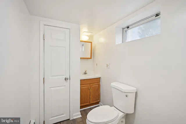 a white toilet sitting next to a bathroom sink