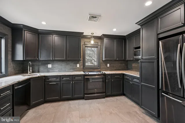 a kitchen with a sink stainless steel appliances and cabinets