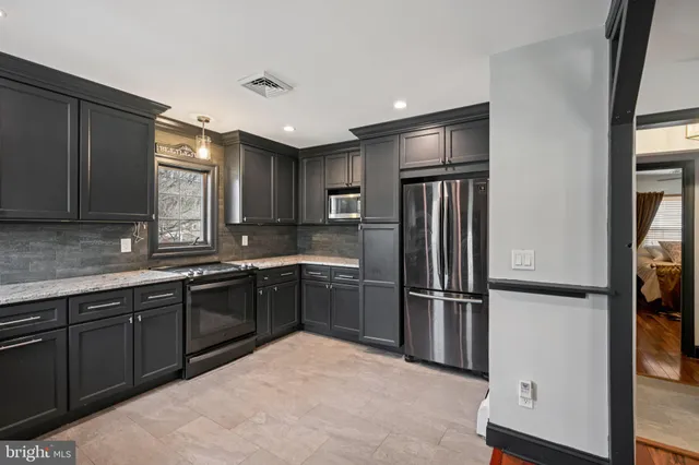 a kitchen with a refrigerator stove and sink